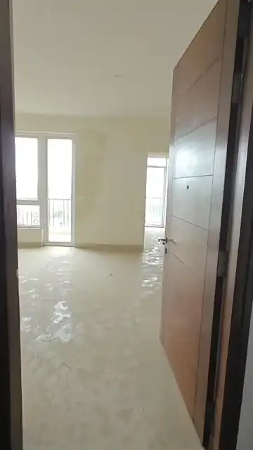 Entrance and living area in the unused 3 BHK + 1 apartment for sale at Emaar Emerald Estate Sector 65 Gurgaon
